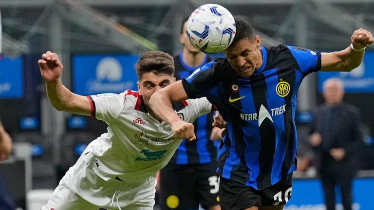 Inter Milan's Alexis Sanchez, right, heads the ball during the...