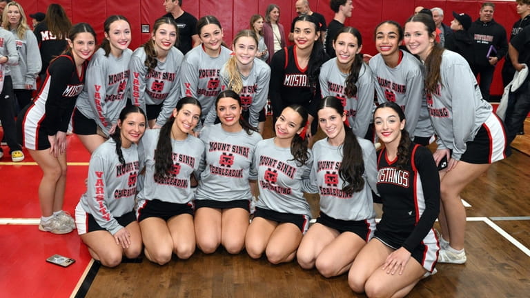 Mt .Sinai poses with its championship plaque at the Suffolk cheerleading finals on...