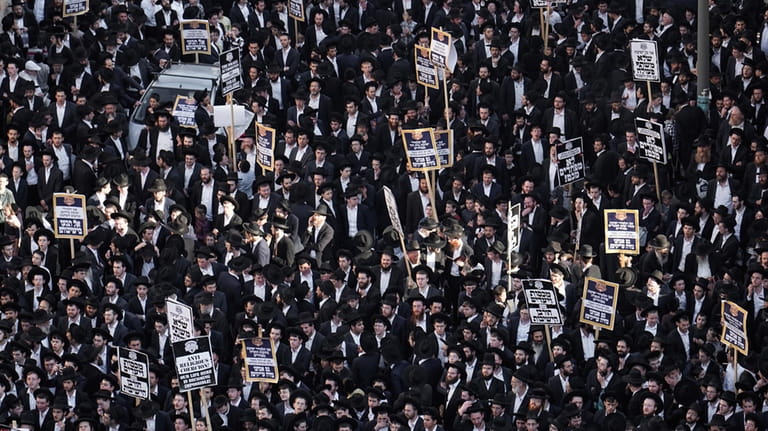 Ultra-Orthodox Jewish men protest against army recruitment, in Jerusalem, Thursday,...