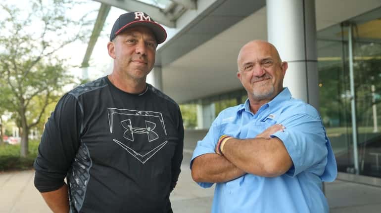 Patchogue Medford High School baseball coach Anthony Frascogna, left, and...