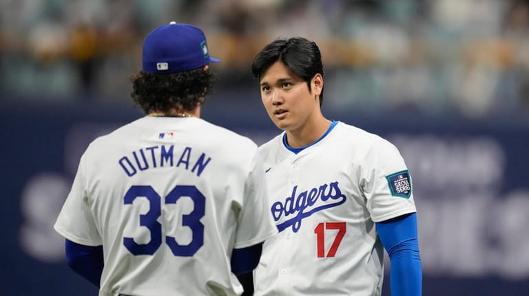 Los Angeles Dodgers' designated hitter Shohei Ohtani, right, talks with...