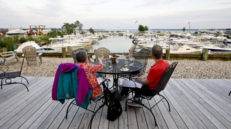Diners sit on the outdoor deck at A Lure in...