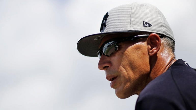 New York Yankees manager Joe Girardi watches from the dugout...
