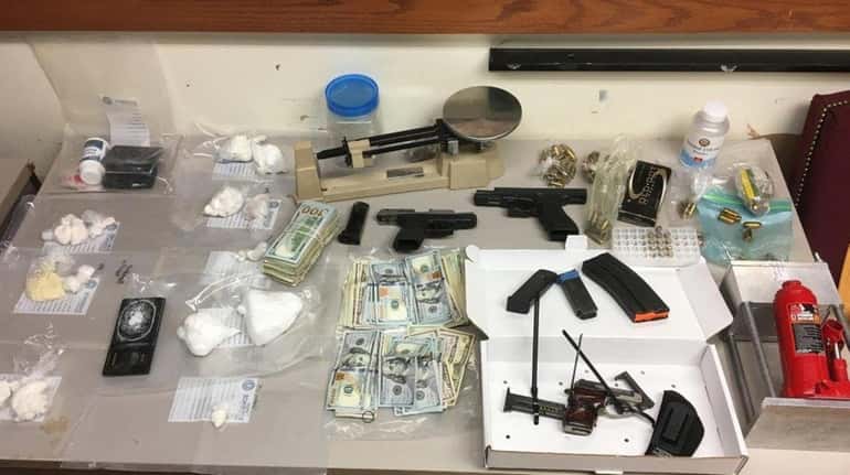 Drugs, guns, ammunition and cash were found by officers executing...
