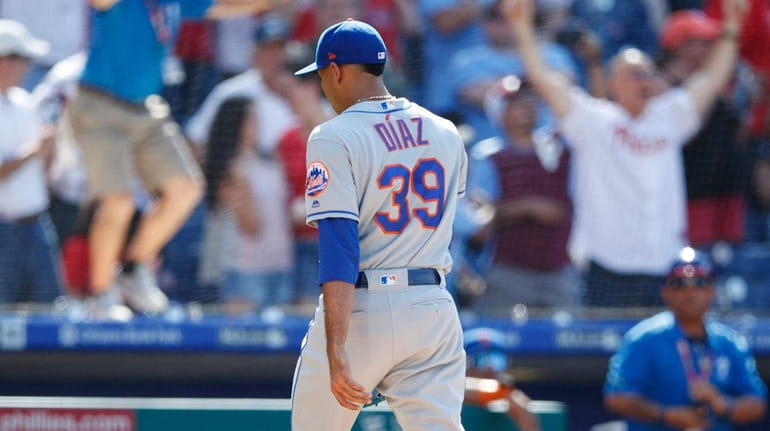 Mets relief pitcher Edwin Diaz walks off the field after...