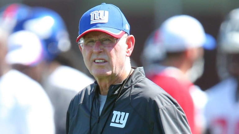 New York Giants head coach Tom Coughlin looks on during...