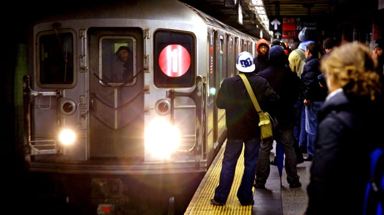 Subway riders get ready to board a No. 1 train...