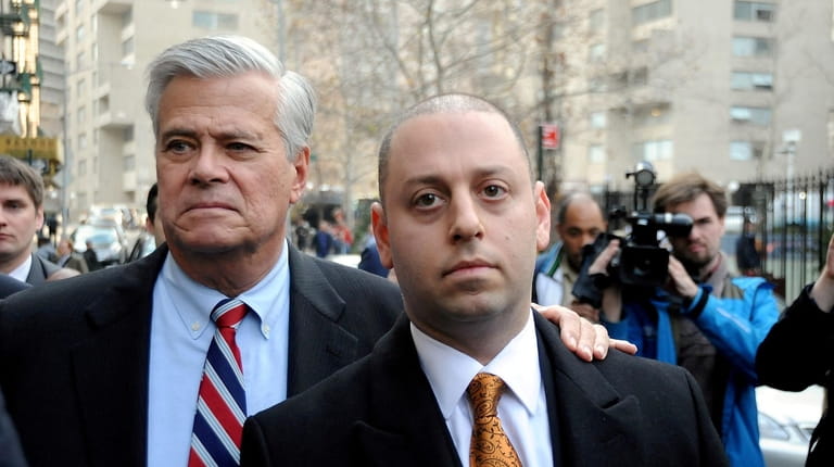 Dean Skelos, left, and his son, Adam,  leave federal court in Foley...