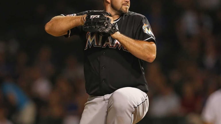 Heath Bell of the Miami Marlins pitches during the 9th...