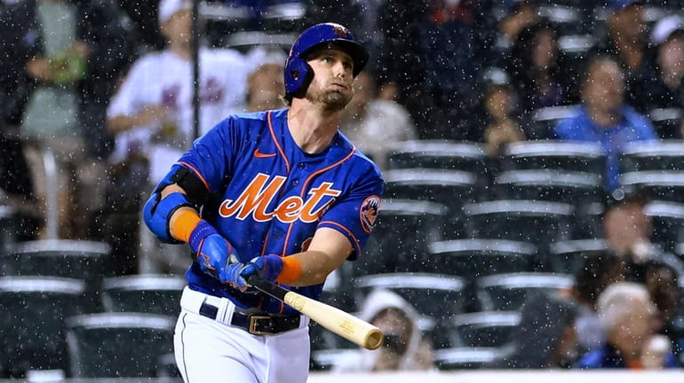 Mets' Jeff McNeil watches his three-run home run against the...