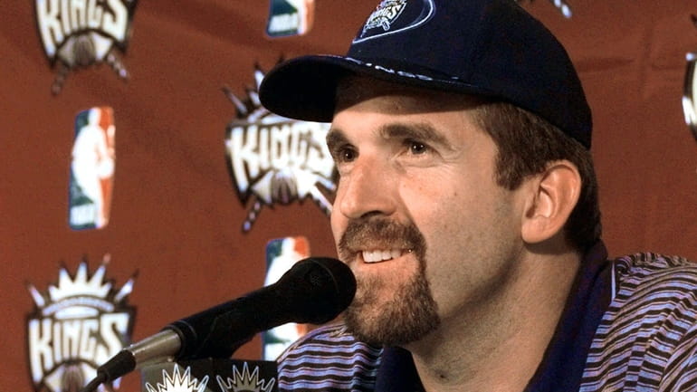 Newly-acquired free agent center Bill Wennington smiles as he talks...