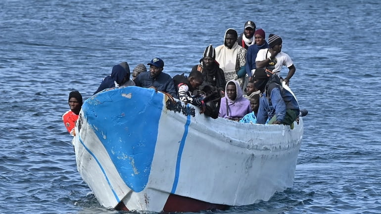 Migrants arrive on a small boat at La Restinga port...