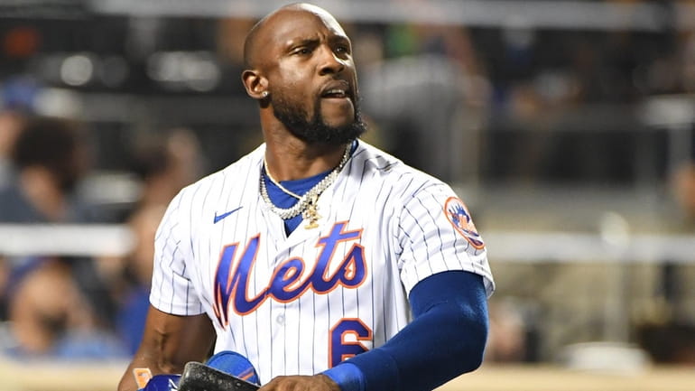 The Mets' Starling Marte reacts after he struck out swinging...