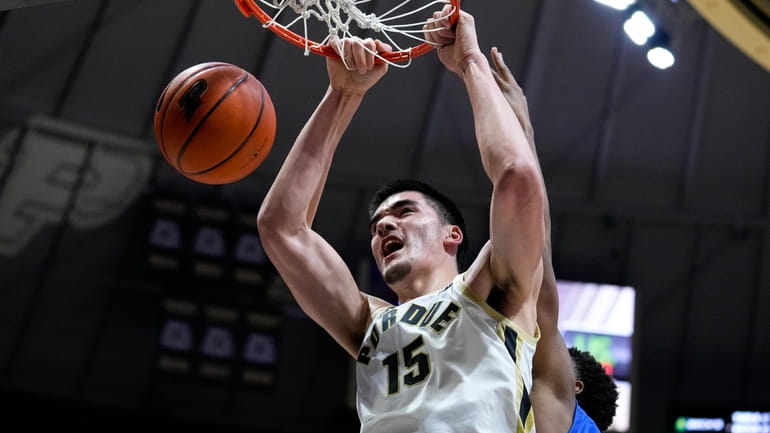 Purdue center Zach Edey (15) gets dunk in front of...