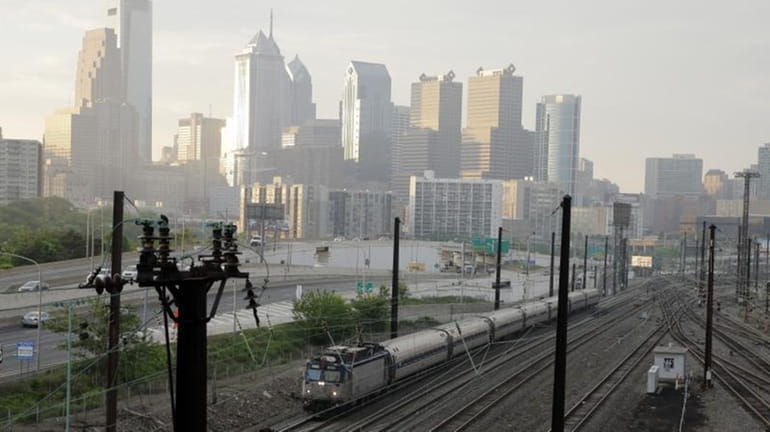 An Amtrak train travels northbound from 30th Street Station, Monday,...
