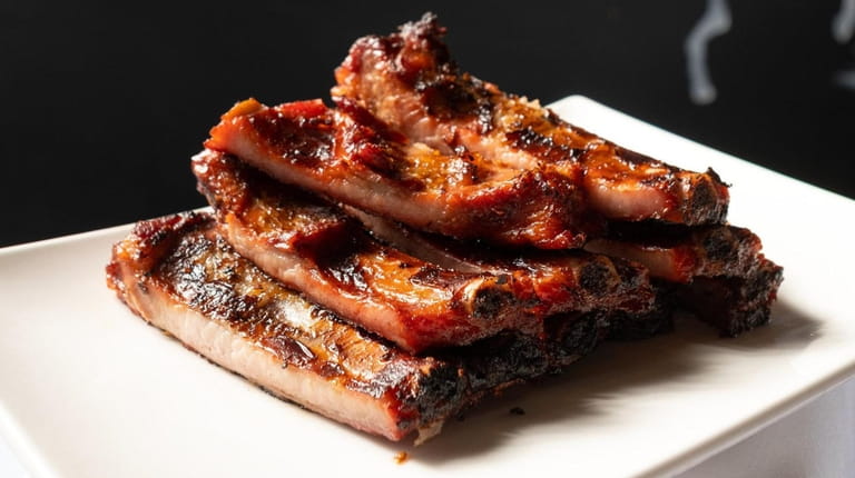 Pork BBQ spare ribs are lacquered in sweet and tangy...