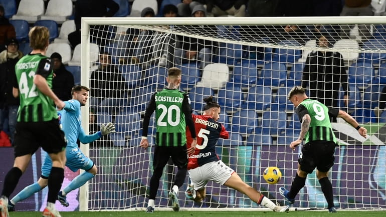 Sassuolo's Andrea Pinamonti, right, scores the opening goal during the...