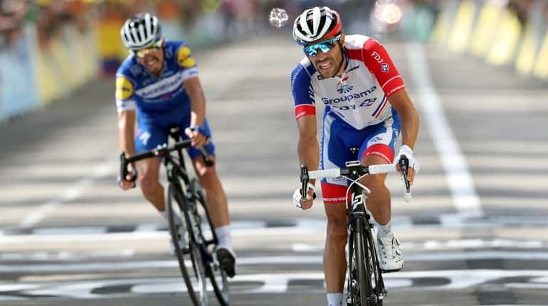 France's Thibaut Pinot, right, and France's Julian Alaphilippe crosse the...