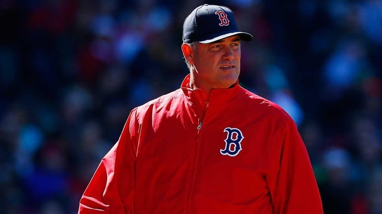 Manager John Farrell of the Boston Red Sox walks back...