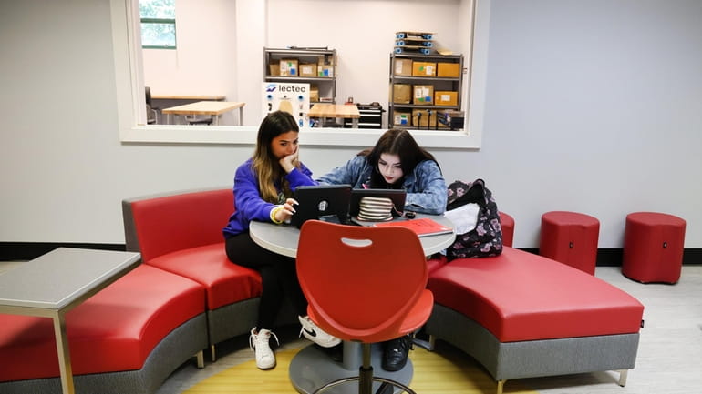 Students Taylor Contreras, 15, left, and Rebecca Earley, 15, collaborate in the...