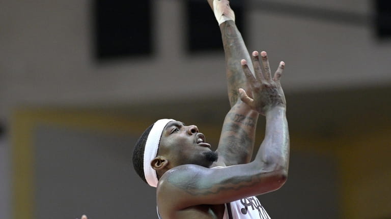 Texas A&M guard Tyrece Radford, right, shoots in front of...