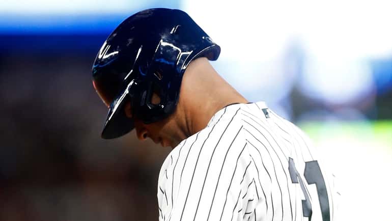 Aaron Hicks of the Yankees reacts after hitting into a fourth-inning-ending...