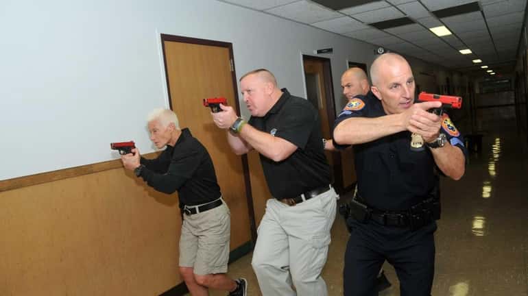 From left, Nassau Police officers Linda Brymer, Danny Hastings and...