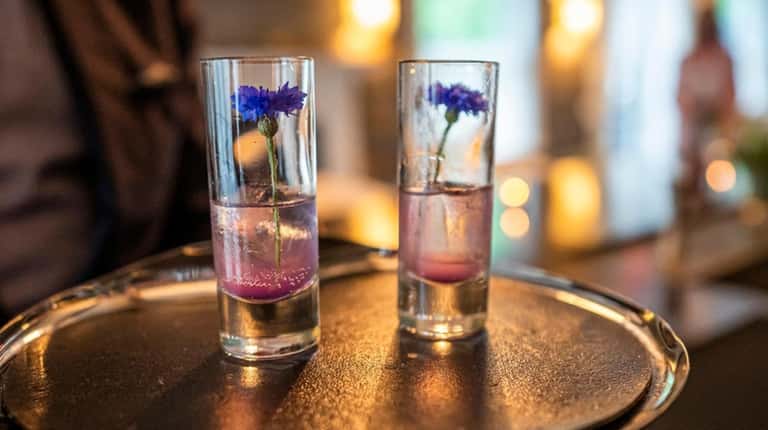 A blue cocktail "amuse" is made with cornflower-infused gin and...