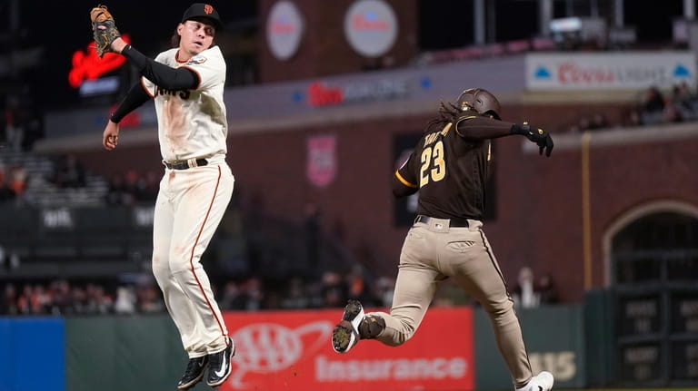 San Diego Padres' Fernando Tatis Jr. (23) reaches first base...