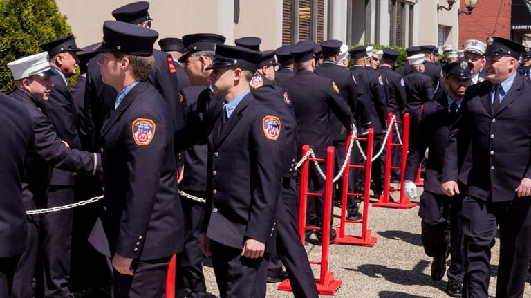 Firefighters wait to pay respects to the late Timothy Klein...
