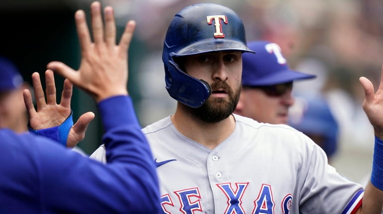 Rangers designated hitter Joey Gallo is greeted in the dugout...