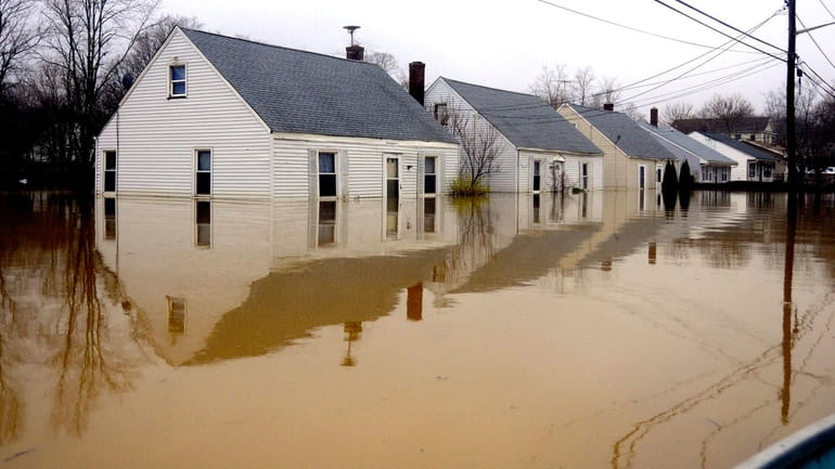 Homes are flooded on Horton Avenue in Riverhead, Wednesday afternoon....