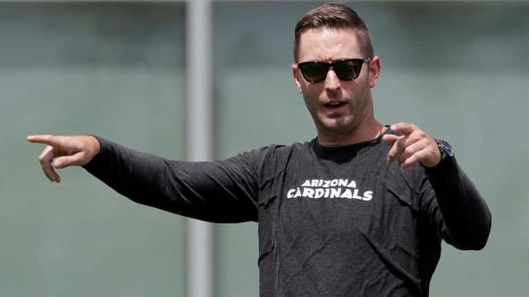 Cardinals head coach Kliff Kingsbury talks to players during an...