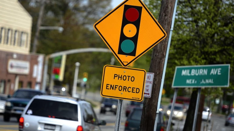 This file photo shows a red light traffic camera sign...