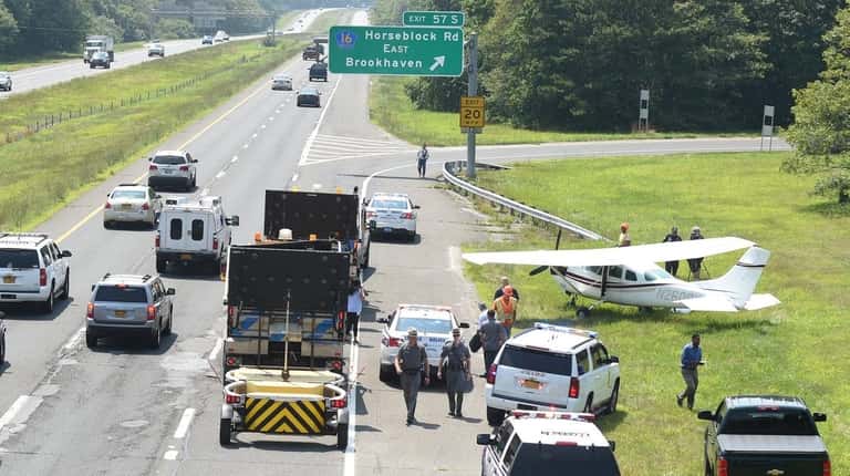 A small plane sits on eastbound Sunrise Highway near Exit...