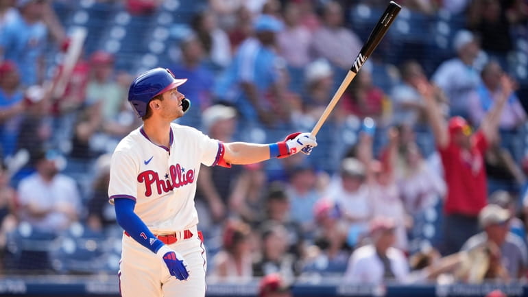 Philadelphia Phillies' Trea Turner watches after hitting a two-run home...