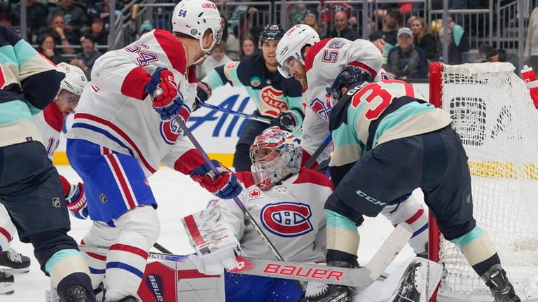 Montreal Canadiens goaltender Cayden Primeau, center, stops the puck during...
