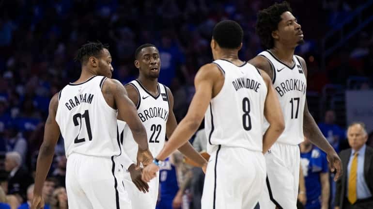 The Nets' Caris LeVert, center left, celebrates with his teammates...