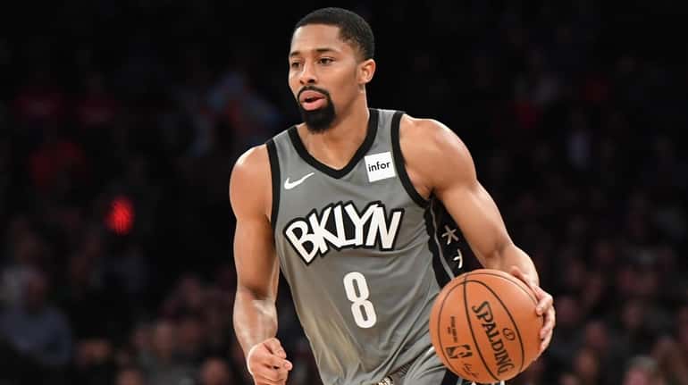 Nets guard Spencer Dinwiddie dribbles the ball upcourt against the...