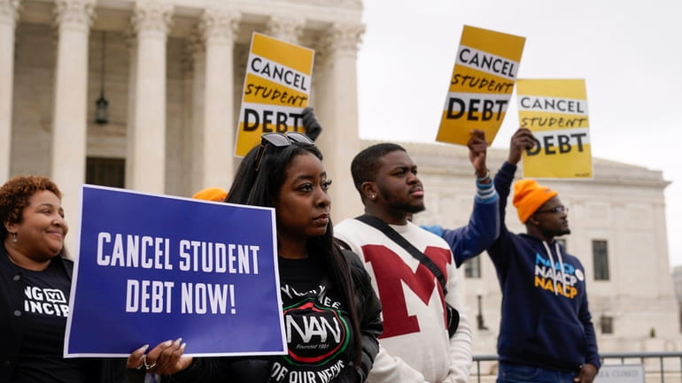 Student debt relief advocates gather outside the Supreme Court in...