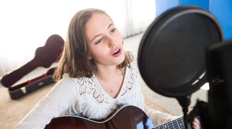 Maddy Seitles, 16, of East Moriches, sings in the newly...