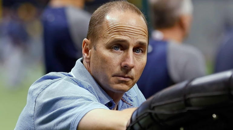General Manager Brian Cashman of the New York Yankees watches...