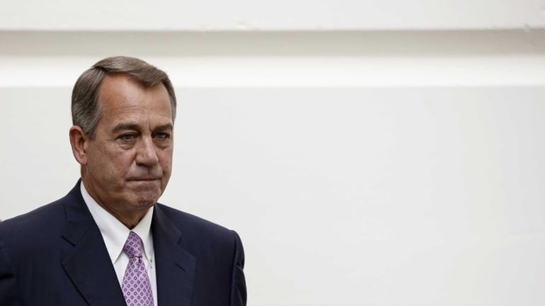 House Speaker John Boehner of Ohio walks to a Republican...