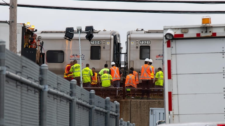 MTA workers on Friday at the scene of the LIRR...