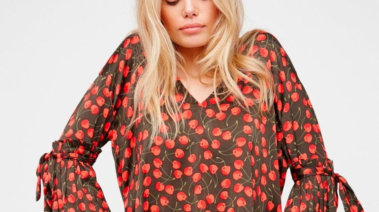 Silky and sassy "cherry pie print"cropped top features exaggerated bell...