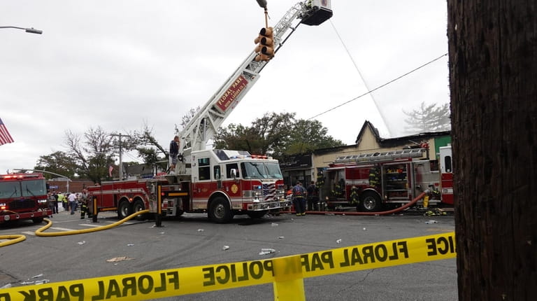 Firefighters at the scene of a fire in a row of...