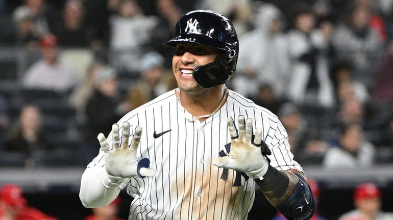 Yankees second baseman Gleyber Torres reacts to the dugout as...