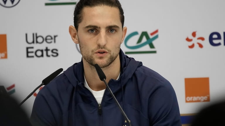France's Adrien Rabiot answers a question during a press conference...
