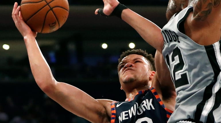 Knicks forward Kevin Knox looks for a shot around the...
