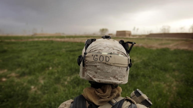 A Marine with the 1st Battalion, 3rd Marines, patrols a...